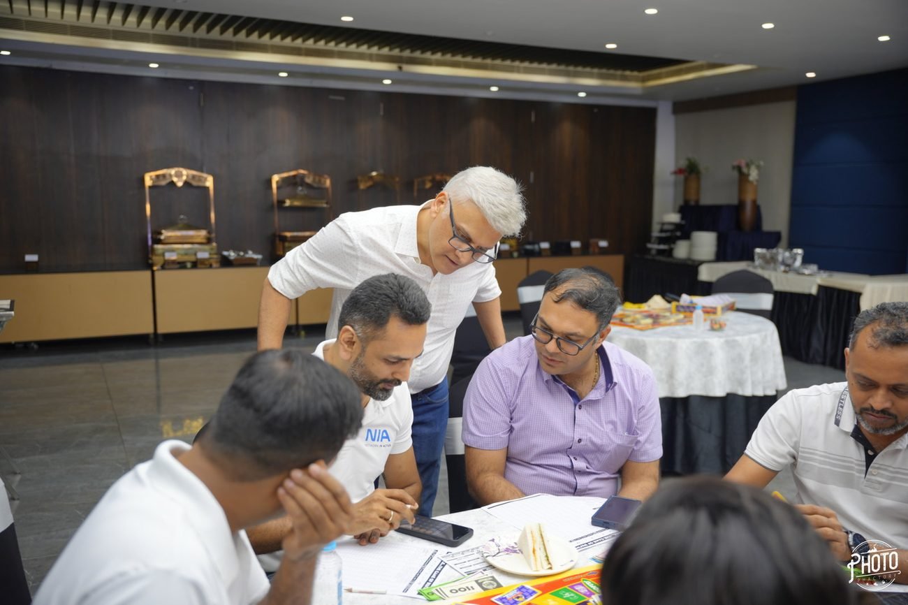 Participants leaning over the board at a table