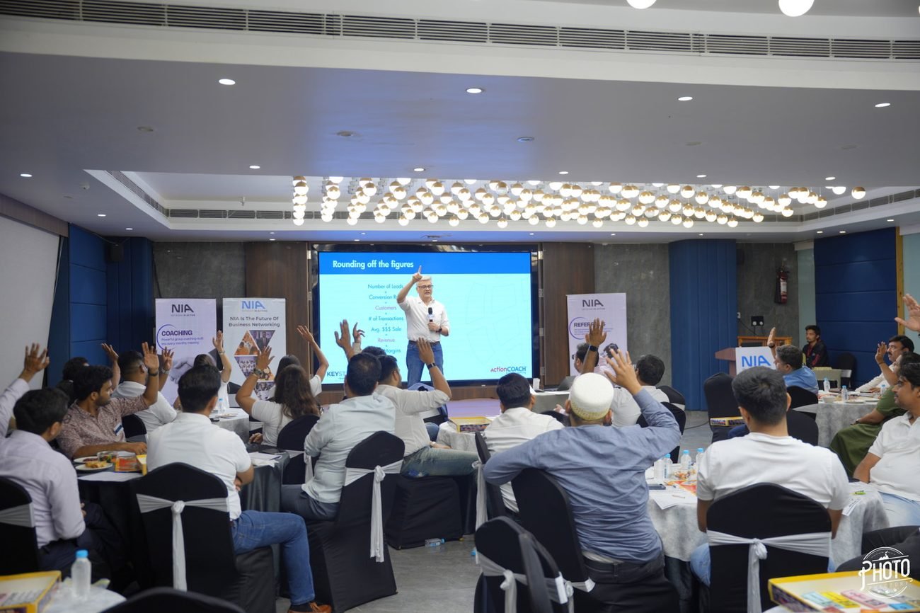 Hands raised across the room during a session